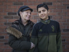 Suzan Deitering is pictured next to 12-year-old, Abdullah Almathoul, Saturday, Dec. 21, 2019, after he found and returned her wallet while riding his bike.