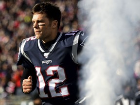 Tom Brady of the New England Patriots runs onto the field before a game against the Miami Dolphins at Gillette Stadium on December 29, 2019 in Foxborough, Massachusetts.