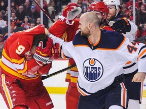 Zack Kassian of the Edmonton Oilers fights Matthew Tkachuk of the Calgary Flames during an NHL game at Scotiabank Saddledome on January 11, 2020 in Calgary, Alberta, Canada.