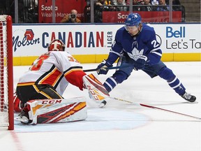 David Rittich #33 of the Calgary Flames stops Kasperi Kapanen #24 of the Toronto Maple Leafs in overtime during an NHL game at Scotiabank Arena on Jan. 16, 2020, in Toronto. The Flames defeated the Maple Leafs 2-1 in a shoot-out.