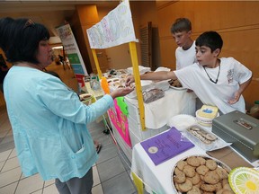 Brennan Tedley and Jaxson Nosella (right) sell baked treats for W.E. Care for Kids at Windsor Regional Hospital in this file photo from 2016.