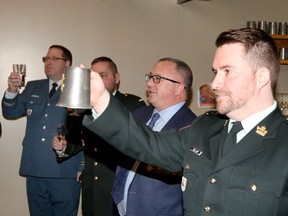 Capt. Kyle Kellam, right, of the Army Reserve Recruiting Office, offers a toast during the New Year's Day Levee at Maj. F.A. Tilston VC. Armoury Wednesday.  Toasts to the Queen, Armed Forces, RCAF, 21 Serice Battalion, cadets and fallen comrades were made, followed by the traditional carving of roast beef.