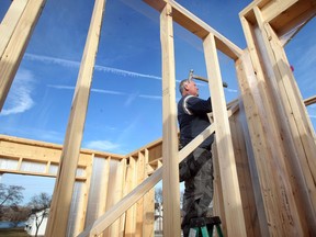 New home framer Joe Grant recently returned to Essex County and immediately took notice of the longer construction season.  "There's a lot more snow in Orillia," said Grant.  In photo, Grant works on single family home for Azar Homes on Mountbatten Crescent in East Riverside.