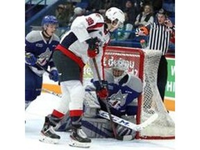 SUDBURY, ON. JANUARY 4, 2020 -- Windsor Spitfires vs. Sudbury Wolves game in Sudbury on Saturday, January 4, 2020, in Sudbury, ON. (BEN Windsor Spitfires’ forward Curtis Douglas tries to jam a puck past Sudbury Wolves’ goalie Christian Purboo as Sudbury’s Owen Gilhula looks to defend during Saturday’s game at the Sudbury Community Arena.