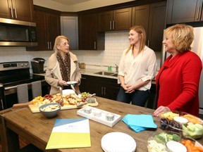 West Bridge Place tenant Christine Lecours, left, chats with Piroli Group representatives Danielle Vanhie and Anne Halls, right, during opening night of model rooms at the huge rental apartment project at 850 Wyandotte Street West Wednesday.  West Bridge Place's Ambassador unit, shown, has two bedrooms and two baths and will be priced at $1790-$2025 per month.
