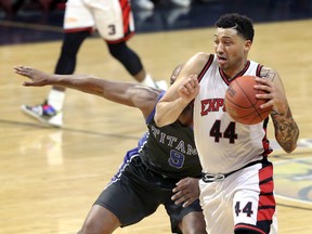 Windsor Express's Ryan Anderson, right, drives against K-W Titans Tramar Sutherland in NBL Canada action from Windsor WFCU Centre Friday.