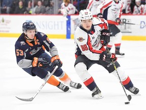 Defenceman Ruben Rafkin, seen early this season trying to elude Flint Ty Dellandrea, will not be returning to the Windsor Spitfires next season and will play pro in Finland.