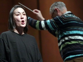 Teiya Kasahara performs the part of Cio-Cio San during Windsor Symphony Orchestra's rehearsal of Puccini's Madama Butterfly at Capitol Theatre Monday. Behind, Maestro Robert Franz conducts.