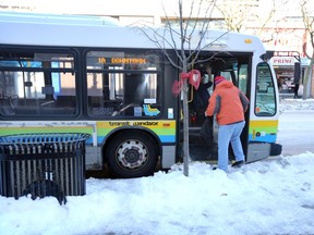 Transit Windsor 1A bus picks up passengers on Ouellette Avenue Monday.