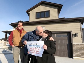 Brentwood Lottery home winners Art and Darlene Formosa celebrate with long kiss as they were officially declared lottery winners by holding the matching ticket in Belle River Tuesday.  Homebuilder Jeff Sylvestre, left, smiles during the announcement.