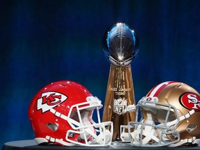 Helmets for the Kansas City Chiefs and San Francisco 49ers are placed in front of the Vince Lombardi Trophy