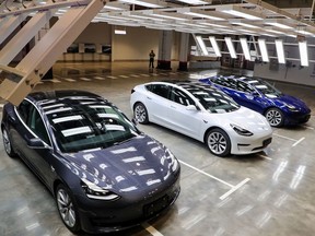 Tesla Model 3 cars are displayed during the Tesla China-made Model 3 Delivery Ceremony in Shanghai. - Tesla CEO Elon Musk presented the first batch of made-in-China cars to ordinary buyers on January 7, 2020 in a milestone for the company's new Shanghai "giga-factory", but which comes as sales decelerate in the world's largest electric-vehicle market.