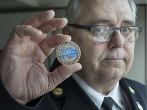 Essex Fire and Rescue Chief Rick Arnel, holds an All In Coin, a new mental wellness initiative launched Thursday by Essex-Windsor EMS and Essex Fire.