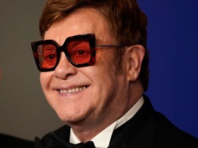 Elton John poses backstage after winning Best Original Song — Motion Picture award for "I'm Gonna Love Me Again" at the 77th Golden Globe Awards in Beverly Hills on Jan. 5, 2020.