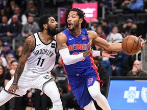 Detroit Pistons guard Derrick Rose drives to the basket against Brooklyn Nets guard Kyrie Irving during the first quarter at Little Caesars Arena.