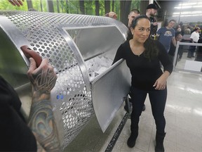 Tatiana Guerrero pulls a ticket from the large metal barrel — new this year — at the Brentwood Recovery Home on Saturday, Jan. 18, 2020 ,during the organization's annual dream home lottery draw.