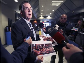 MP Brian Masse speaks to reporters at the City of Windsor 400 building on Wednesday, Jan. 8, 2020, regarding issues he would like to present to Prime Minister Justin Trudeau. He displays a photo of a betting lounge in Michigan where single-game betting is permitted.