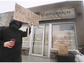 A protester carries a placard Saturday, Jan. 18, 2020, in front of Compassion House in west Windsor.