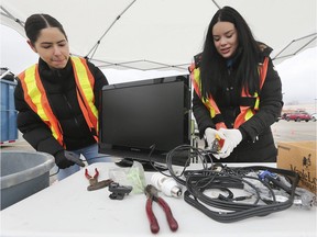 The Habitat for Humanity ReStore held its annual free E-waste Recycling event on Saturday, Jan. 4, 2019. Megan Livingstone, left, and Allyshia Seremack-Talbot process some of the items during the event at the south Home Depot drop-off location.