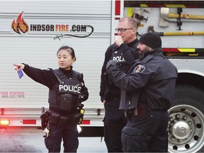 Police officers are shown at the scene of a serious collision on Saturday, January 4, 2020, at the intersection of Lauzon Pkwy. and Forest Glade Drive.