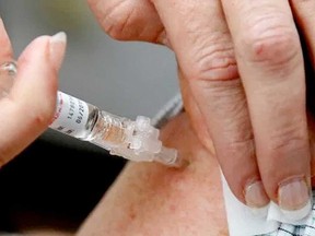 A flu shot is administered in this file photo from January 2020.