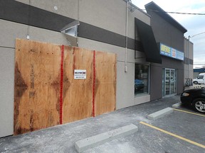 Boards cover a damaged window area at Avenue Shop Swap & Sell, 5876 Tecumseh Rd. East in Windsor on Jan. 16, 2020. Windsor police say a front end loader was driven into the building in a break-and-enter incident around 2 a.m. that morning.