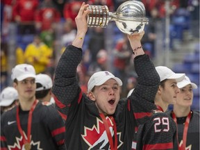 Bowen Byram celebrates with the trophy after Canada defeated Russia in the gold medal game at the World Junior Hockey Championships on Sunday, Jan. 5, 2020 in Ostrava, Czech Republic.