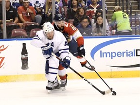 Florida Panthers centre Vincent Trocheck (21) and Toronto Maple Leafs defenceman Morgan Rielly (44) fight for the puck during the second period in Sunrise, Fla.