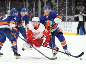 Detroit Red Wings centre Valtteri Filppula (51) is upended by New York Islanders defencemen Nick Leddy (2) and Ryan Pulock (6) during the third period at Nassau Veterans Memorial Coliseum in Uniondale, NY, Jan. 14, 2020.