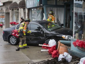 Firefighters deal with a car that crashed into The Vintage House and The Carriage Trade Antiques in the 4600 block of Wyandotte Street East on Jan. 28, 2020.