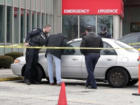 A silver Ford Escort is the subject of investigation near the emergency entrance of the Ouellette Campus of Windsor Regional Hospital on Jan. 27, 2020.