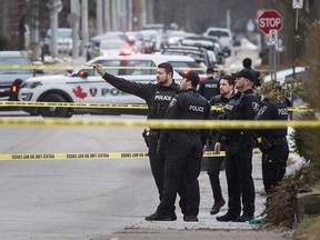 Windsor police officers fill the 1300 block of Pelissier Street as part of an armed robbery investigation on Jan. 27, 2020.