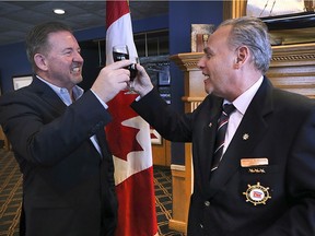 Toasting a port deal with port. Windsor Port Authority president and CEO Steve Salmons, left, raises a glass of wine with George McMahon, Commodore of the Windsor Yacht Club on Friday, Jan. 24, 2020, at a news conference announcing the local yacht club has entered into a 60-year deal to lease and operate the Riverside Marina from the port authority.