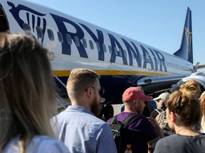 FILE PHOTO: Passengers board a Ryanair flight at the airport in Gdansk, Poland, June 19, 2019.