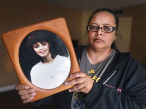 Tasha Porter holds a photo of her mother Sandra Porter on Wednesday at her Windsor home. William Faulkner was convicted of manslaughter in the 1996 death of Sandra Porter. Now he's facing a first-degree murder charge in Michigan.