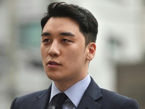 Former Big Bang k-pop band member Seungri, real name Lee Seung-hyun, speaks to the media as he arrives for police questioning in Seoul on August 28, 2019. - Scandal-hit K-pop star Seungri was questioned by police on August 28 for illicit overseas gambling, the latest step in a snowballing sex and drugs scandal that saw him retire in March.