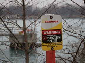 A sign marks where an Enbridge pipeline crosses the St. Clair River between Michigan and Ontario.