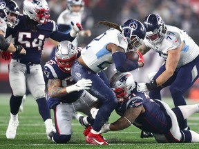 Tennessee Titans running back Derrick Henry runs the ball through the New England defence in Foxboro. (Getty Images)