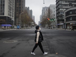 A woman walks on an empty road on January 27, 2020 in Wuhan, China.