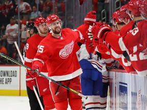 Mike Green of the Detroit Red Wings celebrates his third period goal with teammates while playing the Montreal Canadiens at Little Caesars Arena on February 18, 2020 in Detroit, Michigan. Detroit won the game 4-3.