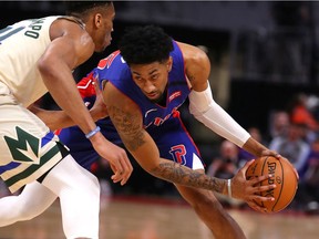 Christian Wood #35 of the Detroit Pistons looks to make a move around Giannis Antetokounmpo #34 of the Milwaukee Bucks during the first half at Little Caesars Arena on February 20, 2020 in Detroit, Michigan.