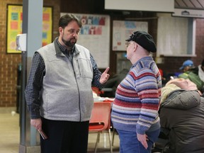 Downtown Mission Executive Director Ron Dunn, left, speaks to a mission visitor about changes to operating hours Wednesday Feb. 5, 2020.