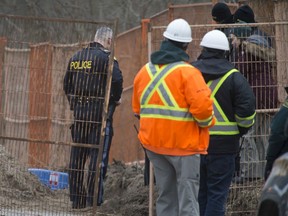OPP officers and officials with Parks Canada work at the scene where skeletal remains were discovered at a construction site at Point Pelee National Park, Feb. 5, 2020.