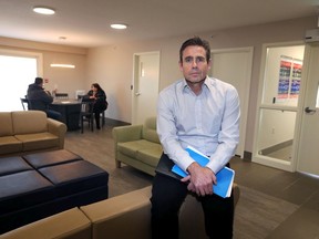 Steven Govette displays the common area of a new home for the Safe Bed Program.