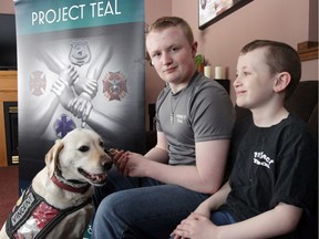 Cameron Cadarette, 15, with his brother Aaron, 11, and service companion Vince are pictured on Friday. Cameron is founder of Project Teal and is about to be awarded an Ontario Junior Citizen award.