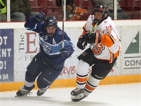 Wheatley Sharks Drew Denomey, left, skates with Essex 73's Riley Meyerink.