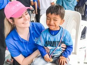 Melanie Renaud of University of Windsor sits with Javier, 6, who is hearing for the first time. Renaud recently traveled to Guatemala as part of hearing foundation to restore hearing with aids for children.