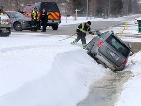 Towing specialist Al Desbien of LaSalle Towing and Recovery prepares to hitch a Pontiac Torrent SUV which did not make it through one of many snow drifts on Broderick Road Thursday.  LaSalle Police and LaSalle firefighters were called to assist several motorists on Broderick and OPP were warning motorist the obvious, to simply slow down due to weather conditions.