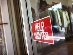 A help wanted sign is seen in the window of the Unika store on Sept. 4, 2015 in Miami, Florida.