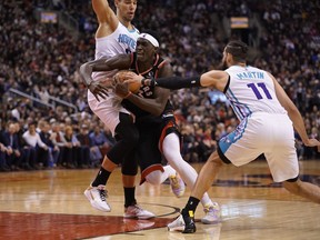 Toronto Raptors forward Pascal Siakam (43) drives to the net against Charlotte Hornets centre Willy Hernangomez (9) and forward Cody Martin (11) at Scotiabank Arena. Charlotte defeated Toronto.